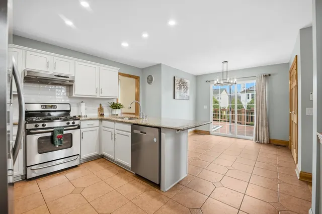a kitchen with stainless steel appliances granite countertop a stove and a sink