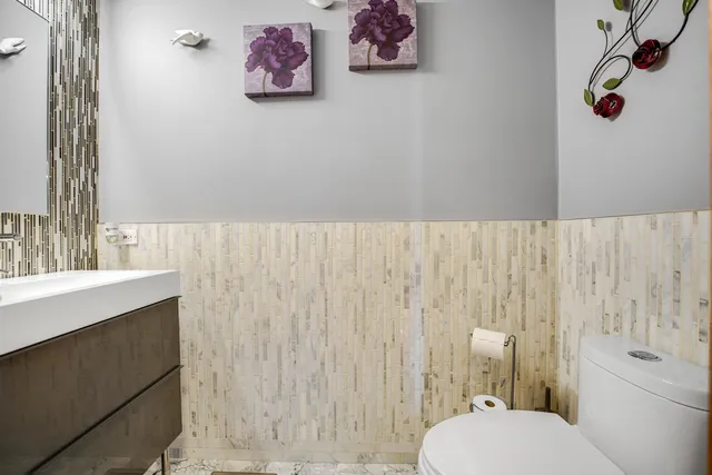 a bathroom with a toilet sink and vanity