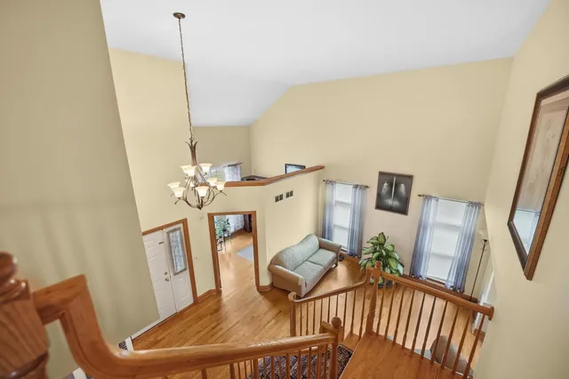 a view of a dining room with furniture wooden floor and chandelier