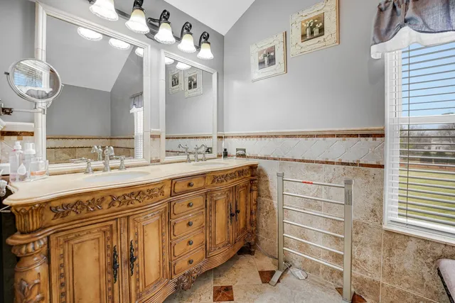 a bathroom with a sink double vanity and a mirror