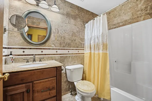 a bathroom with a toilet a sink and a mirror