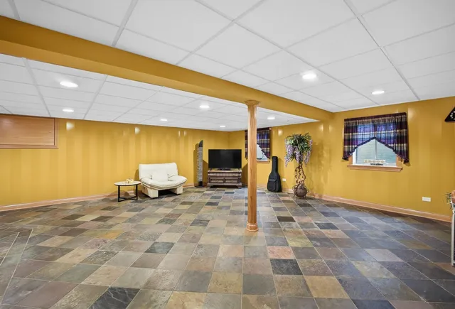a view of a livingroom with a flat screen tv and outdoor seating