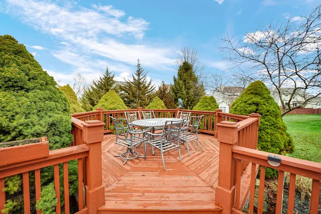 a view of a chair and table on the deck