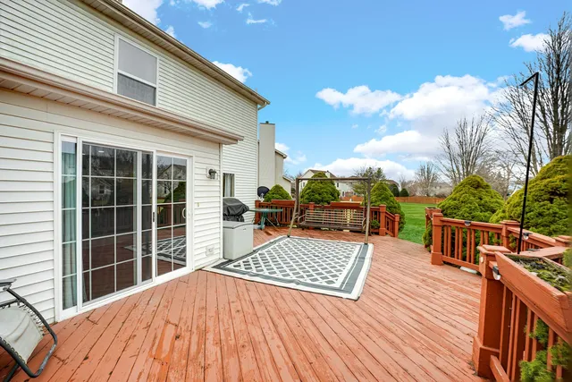 a view of a roof deck with wooden floor and fence