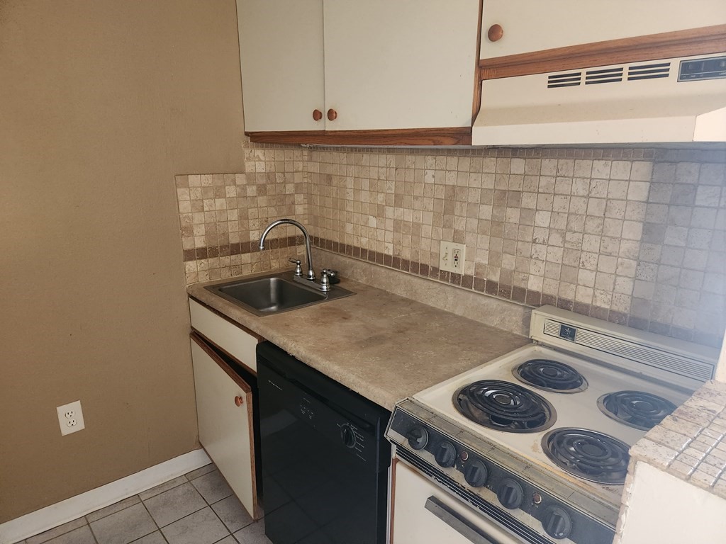 70 Southbridge Street, Unit 302 Worcester, MA 01608 - Photo 10 of 22 a kitchen with a sink stove top oven and cabinets