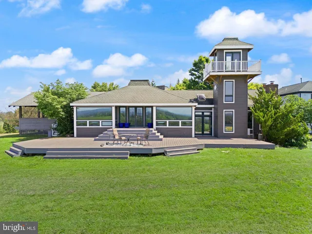 a front view of a house with a yard table and chairs