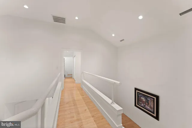 a view of a hallway with wooden floor