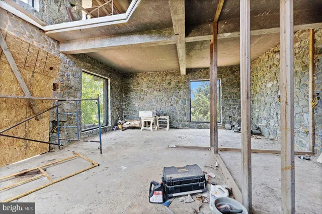 a bedroom with furniture and a tub