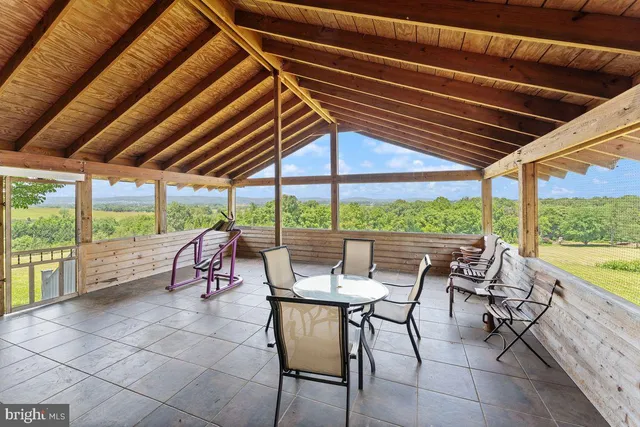 a view of a patio with table and chairs under an umbrella