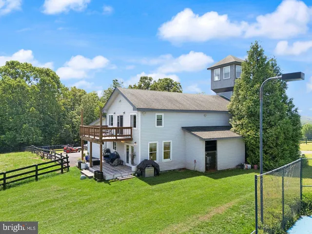a view of a house with a yard and sitting area