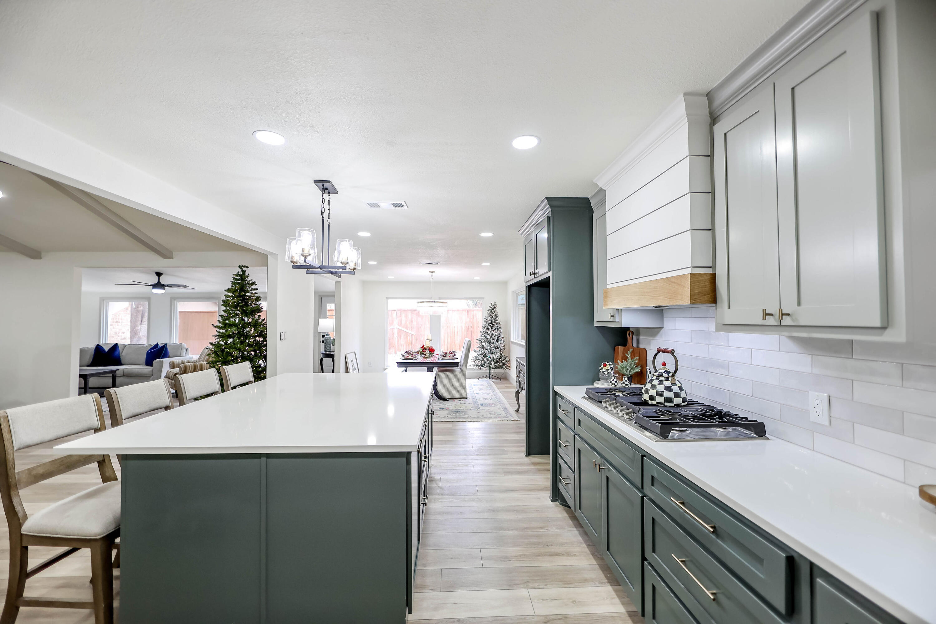 4411 79th Street Lubbock, TX 79424 - Photo 11 of 42 a large kitchen with counter top space a sink stainless steel appliances and cabinets