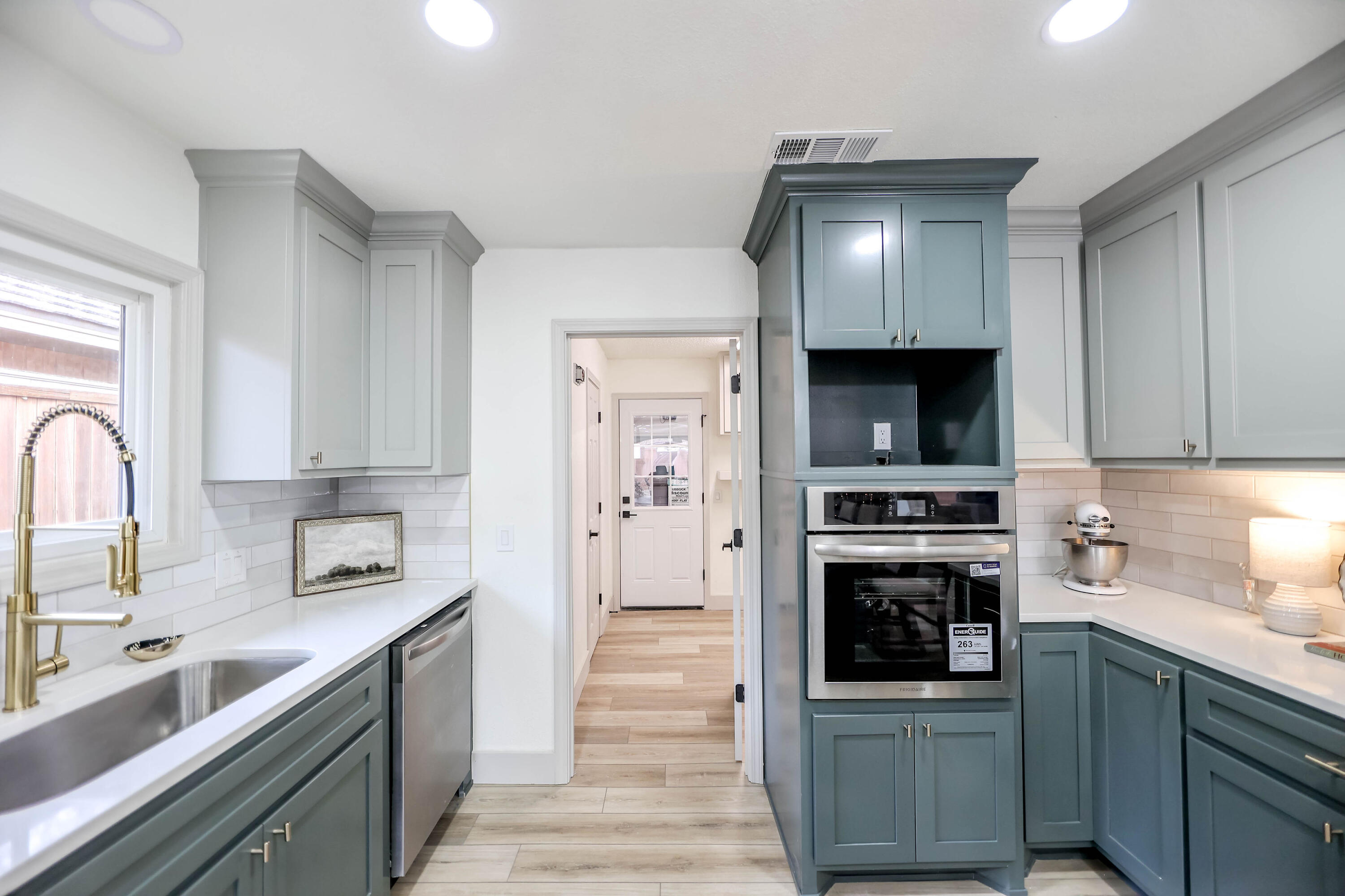 4411 79th Street Lubbock, TX 79424 - Photo 14 of 42 a kitchen with stainless steel appliances a sink stove and cabinets