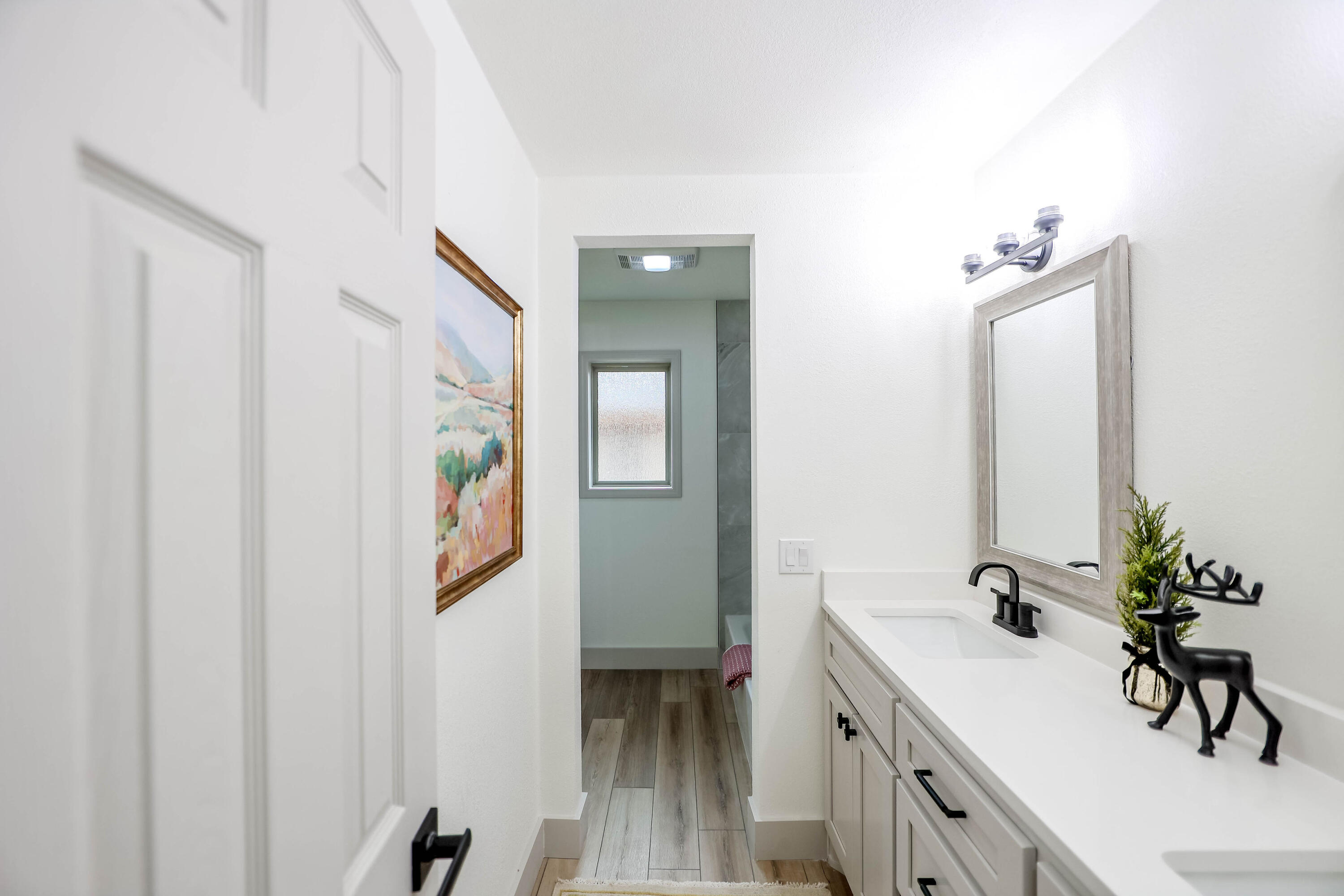 4411 79th Street Lubbock, TX 79424 - Photo 23 of 42 a bathroom with a sink and a mirror
