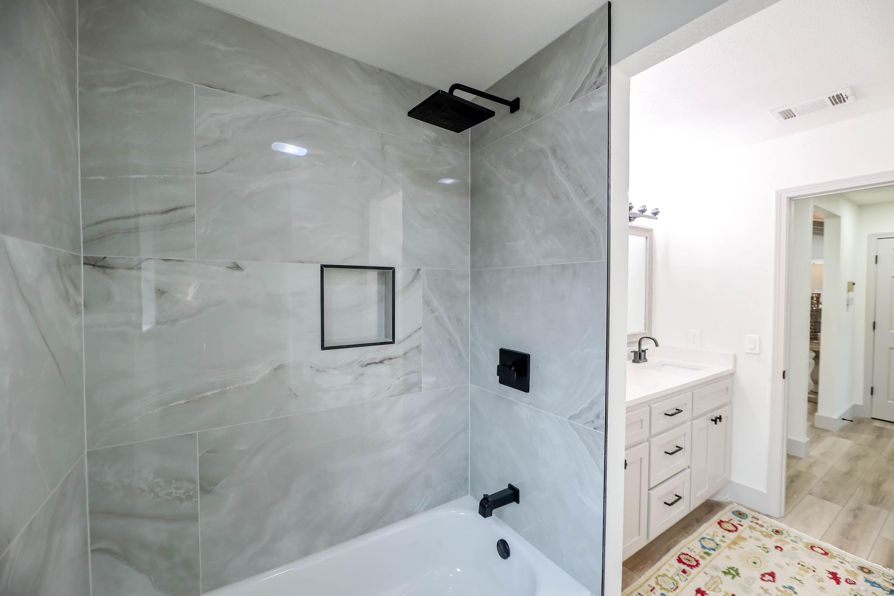 4411 79th Street Lubbock, TX 79424 - Photo 25 of 42 a bathroom with a bathtub and a shower