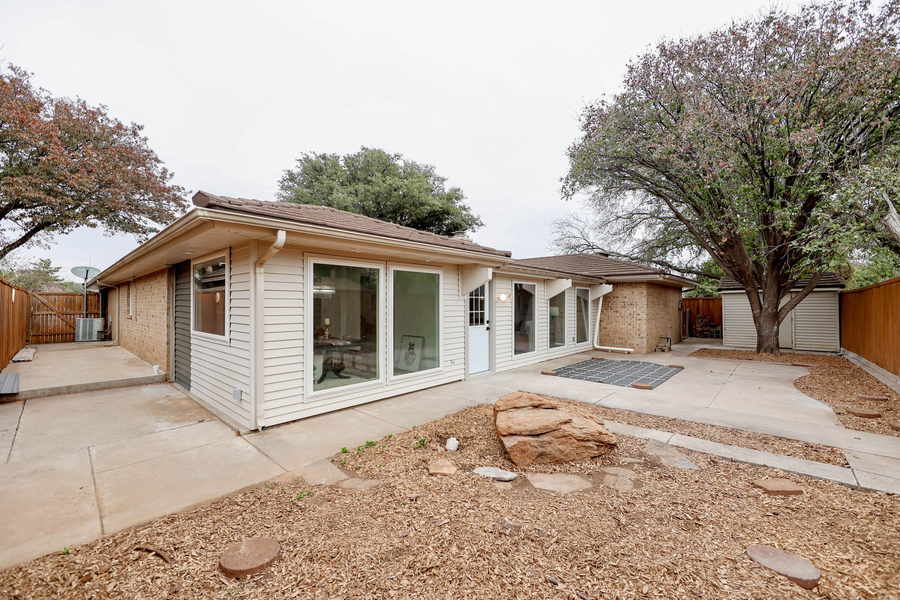 4411 79th Street Lubbock, TX 79424 - Photo 34 of 42 a front view of a house with a garden