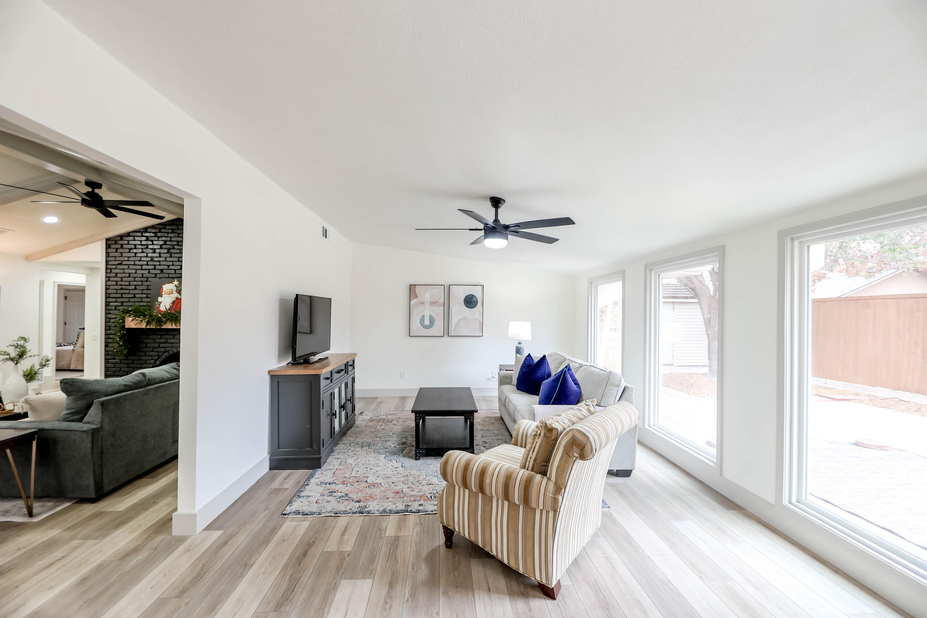 4411 79th Street Lubbock, TX 79424 - Photo 7 of 42 a living room with furniture a large window and stainless steel appliances