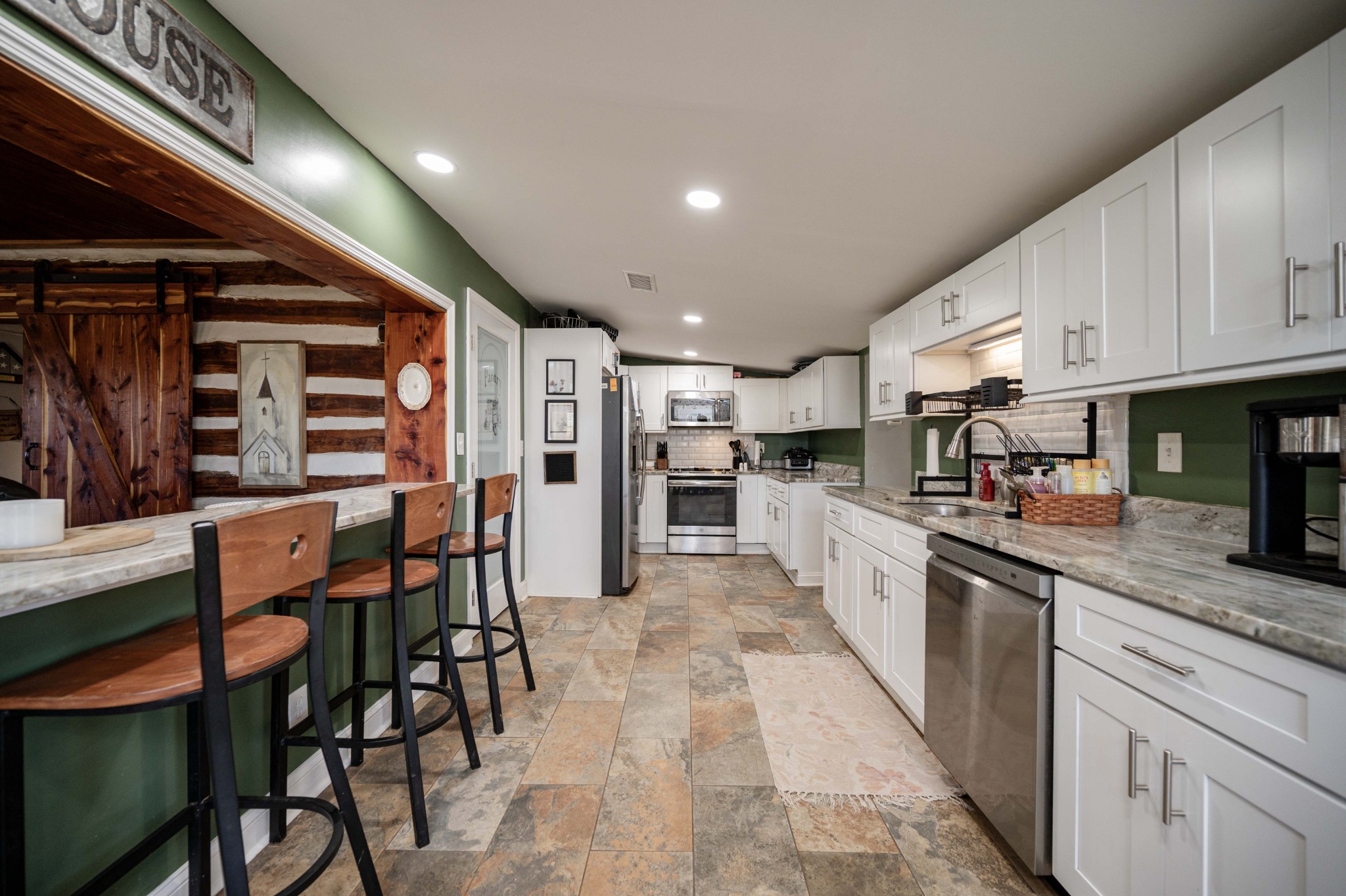 9202 Link Road Christiana, TN 37037 - Photo 12 of 37 a kitchen with stainless steel appliances kitchen island granite countertop a table chairs and a refrigerator