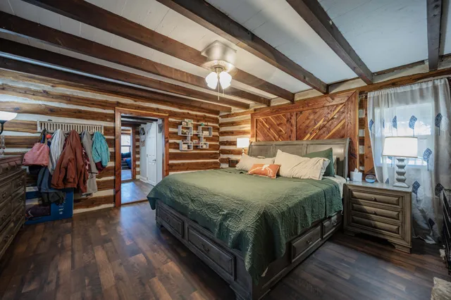 a bed sitting in a bedroom next to a window