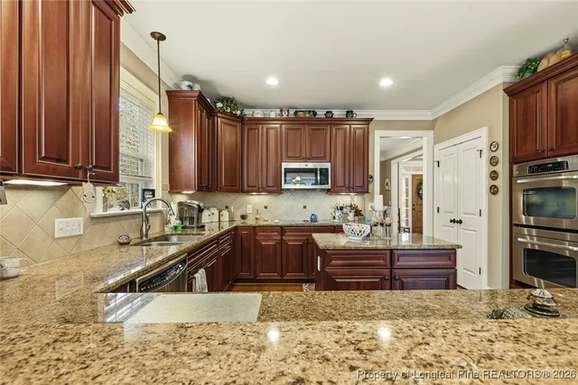 a kitchen with a sink stove and refrigerator
