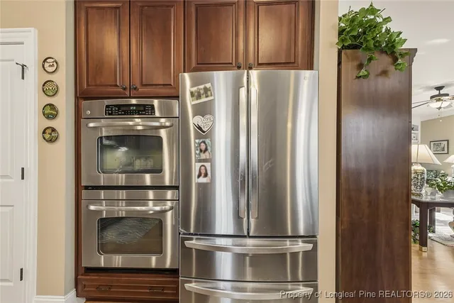 a metallic refrigerator freezer sitting in a kitchen