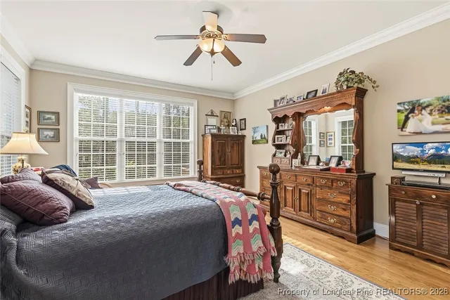 a bedroom with a bed dresser and a window