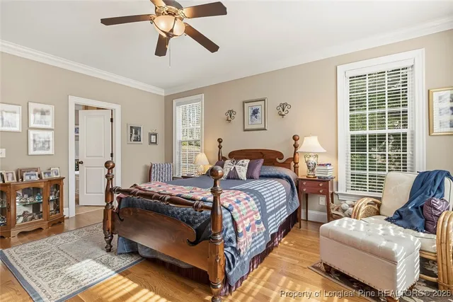 a bedroom with a bed couch and a window