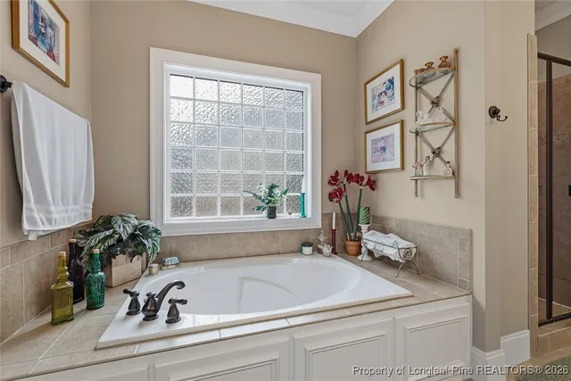 a bathroom with a bathtub sink and mirror