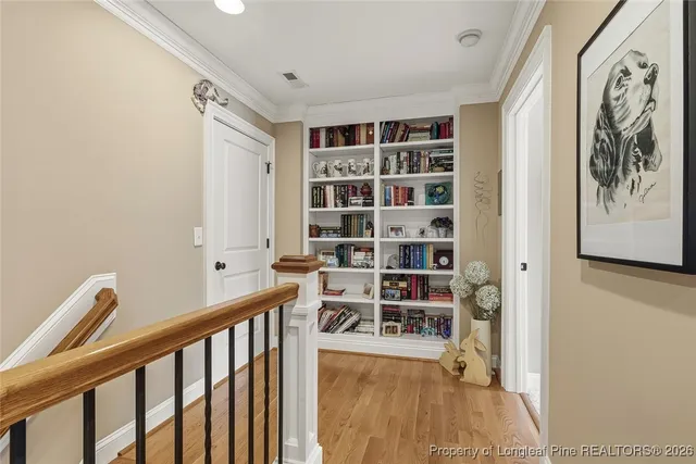 a view of a hallway with wooden floor and a large window