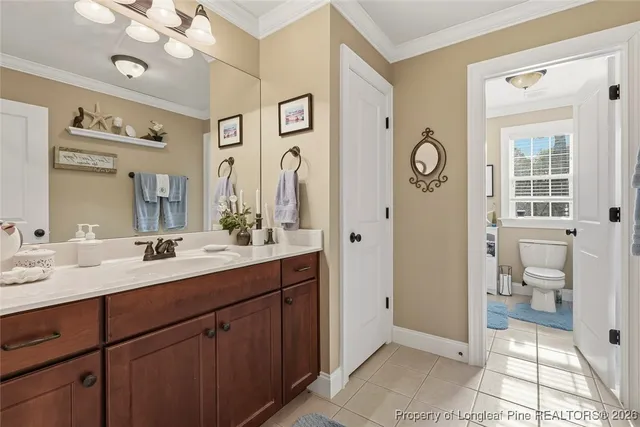 a spacious bathroom with a granite countertop sink mirror and a toilet