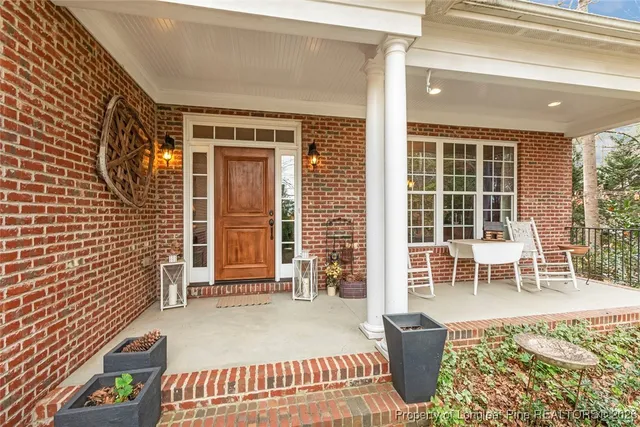 a balcony with table and chairs