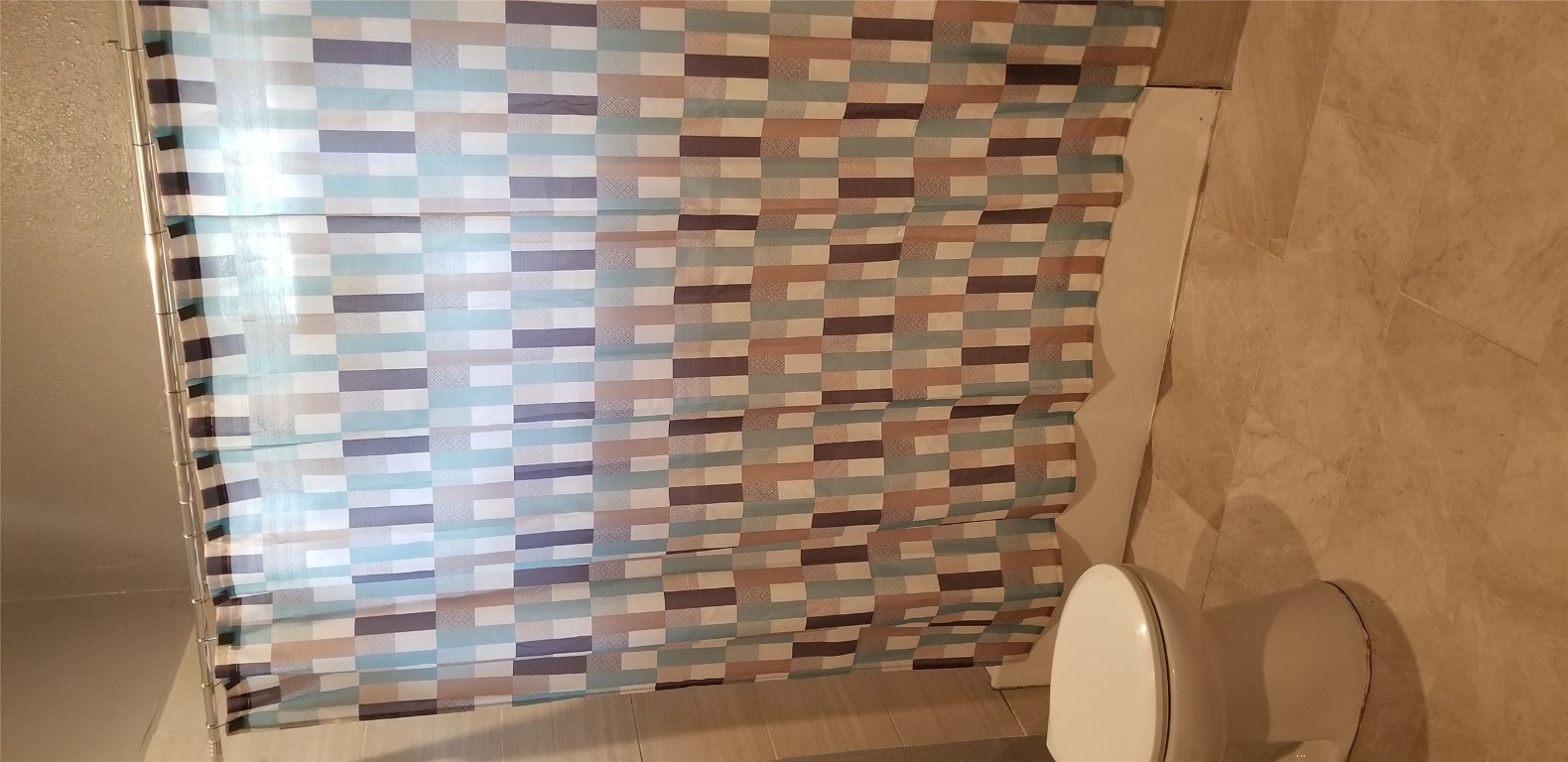 407 South Main Street Taylor, TX 76574 - Photo 13 of 15 a bathroom with a toilet and a shower curtain