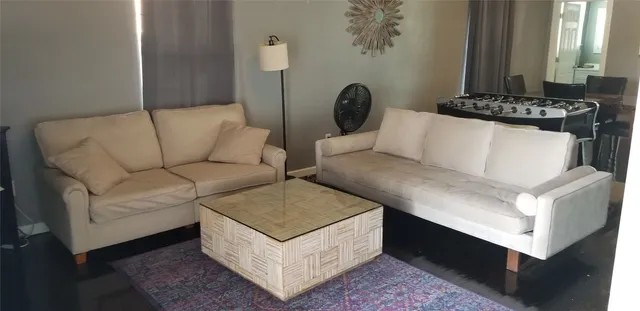 a living room with furniture and a potted plant