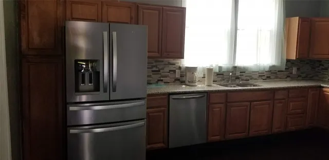 a kitchen with stainless steel appliances a refrigerator and a sink