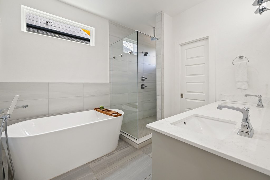 2602 East 13th Street Austin, TX 78702 - Photo 16 of 27 Gorgeous and modern bathroom finishes with a stand-alone tub, walk-in shower and double vanities.