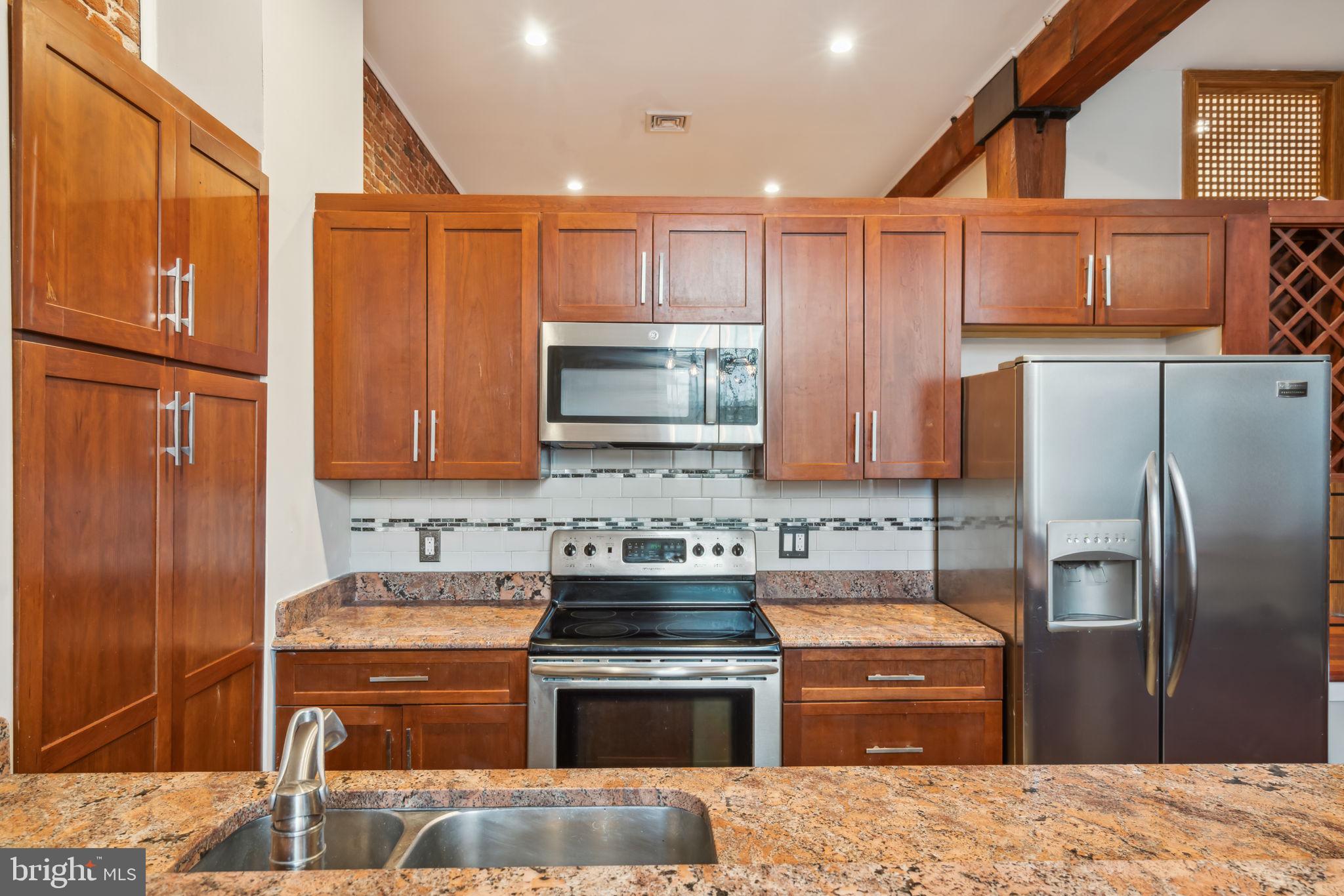 12 Letitia Street, Unit 201 Philadelphia, PA 19106 - Photo 11 of 30 a kitchen with stainless steel appliances granite countertop a refrigerator stove and sink