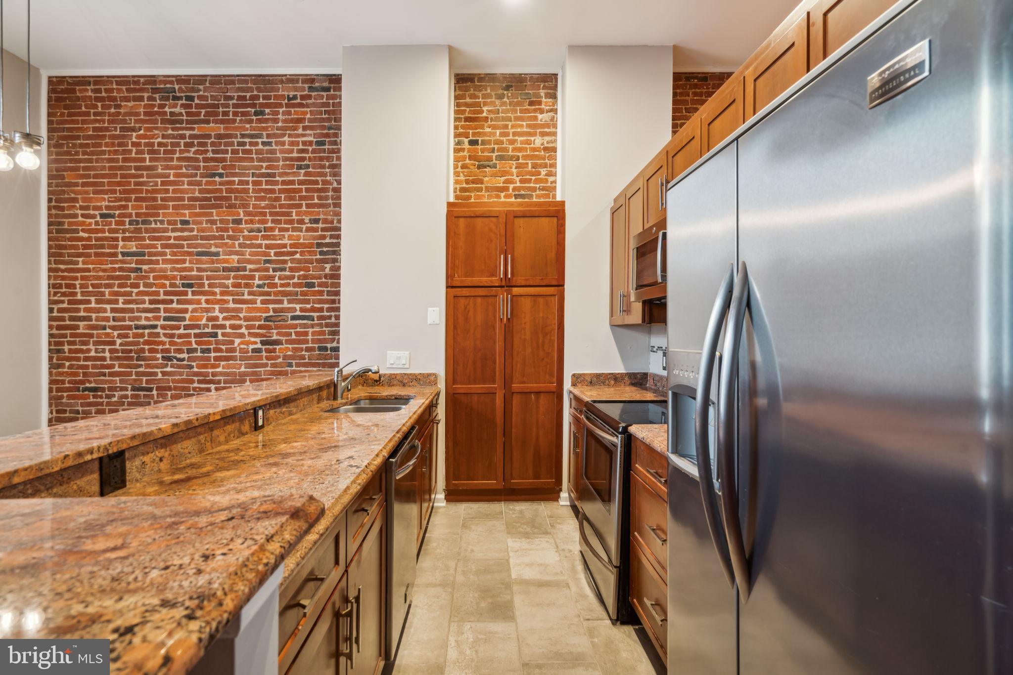 12 Letitia Street, Unit 201 Philadelphia, PA 19106 - Photo 5 of 30 a bathroom with a granite countertop sink and washing machine