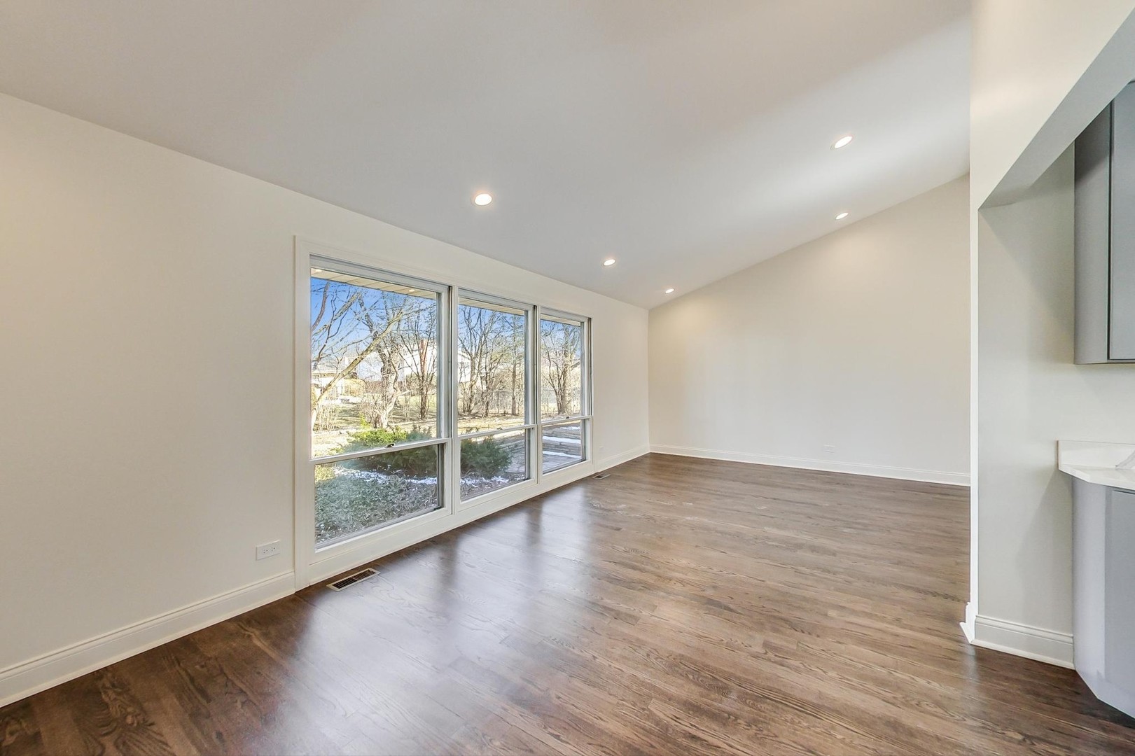 1835 Smith Road Northbrook, IL 60062 - Photo 9 of 54 a view of an empty room with wooden floor and a window