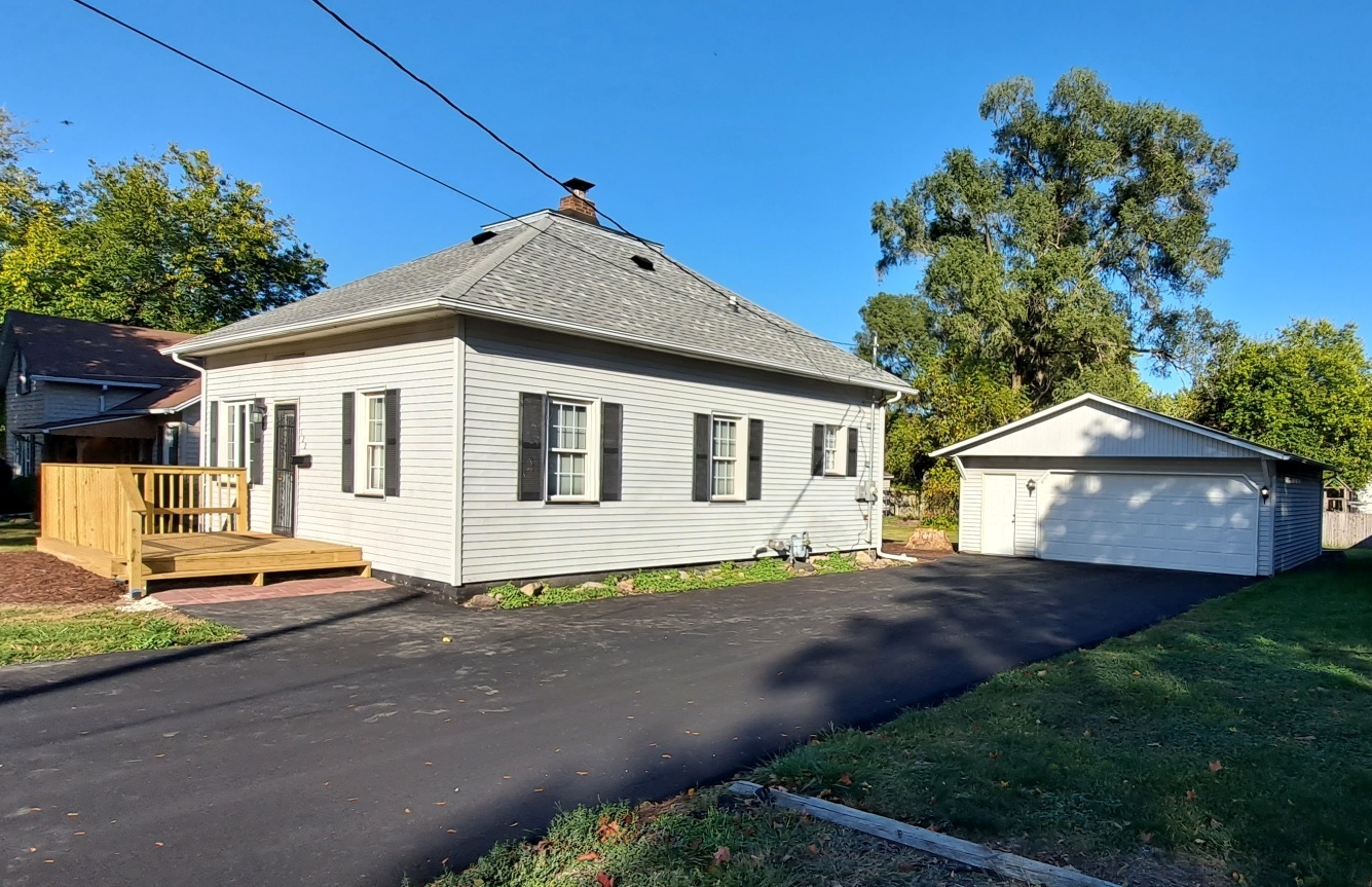 122 Portland Avenue Oglesby, IL 61348 - Photo 1 of 21 a front view of a house with a yard and garage