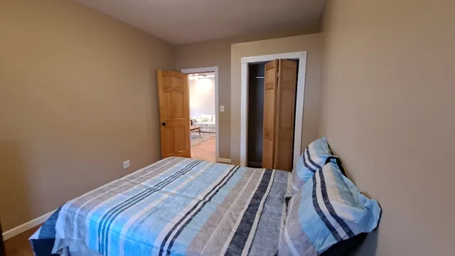 a bedroom with a bed and a window