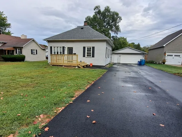 a front view of a house with a garden and yard