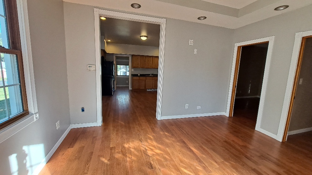 122 Portland Avenue Oglesby, IL 61348 - Photo 6 of 21 wooden floor in an empty room with a window