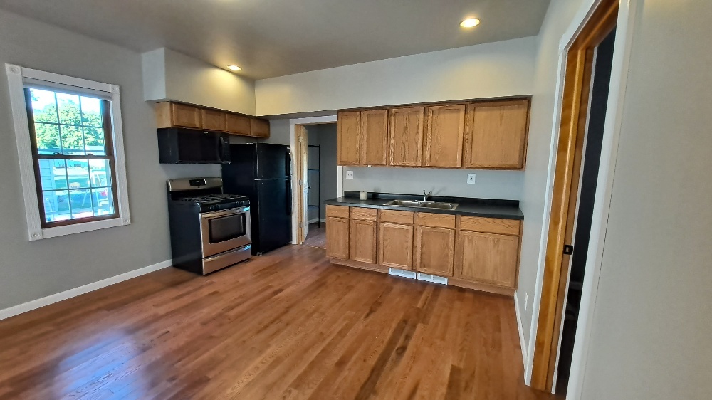 122 Portland Avenue Oglesby, IL 61348 - Photo 7 of 21 a kitchen with wooden floors and appliances