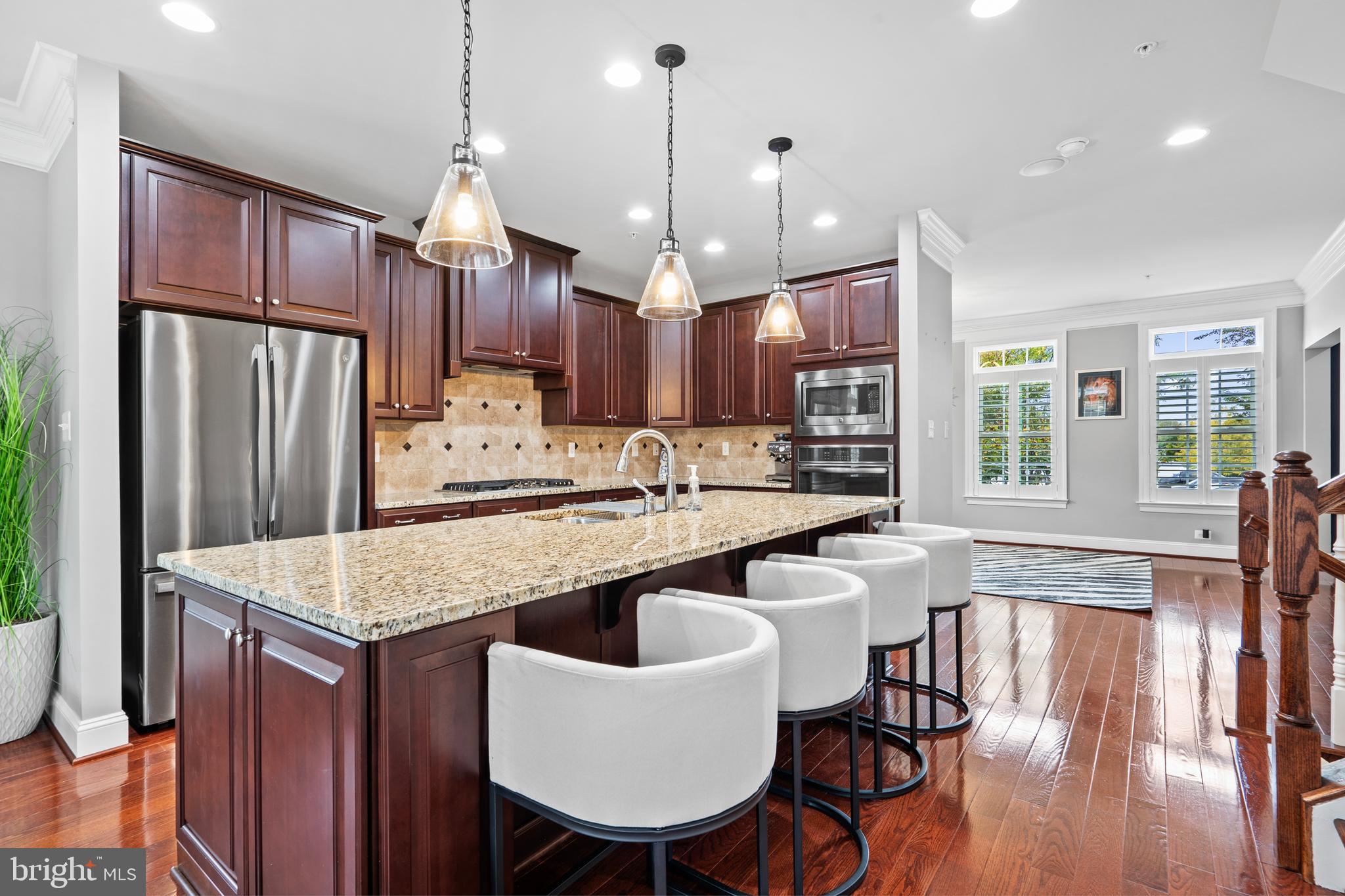 3822 Jacob Stout Road Doylestown, PA 18902 - Photo 18 of 39 a kitchen with stainless steel appliances granite countertop a kitchen island hardwood floor sink stove and wooden cabinets