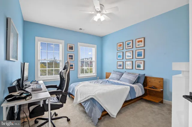 a bedroom with a bed and a desk