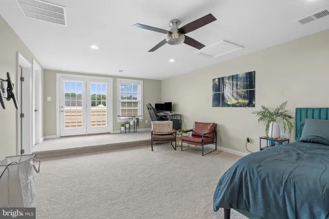 a spacious bedroom with a bed and a large window