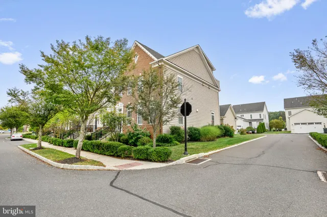 a view of a street with a house in the background