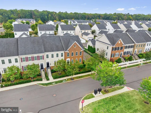 an aerial view of multiple houses with a yard