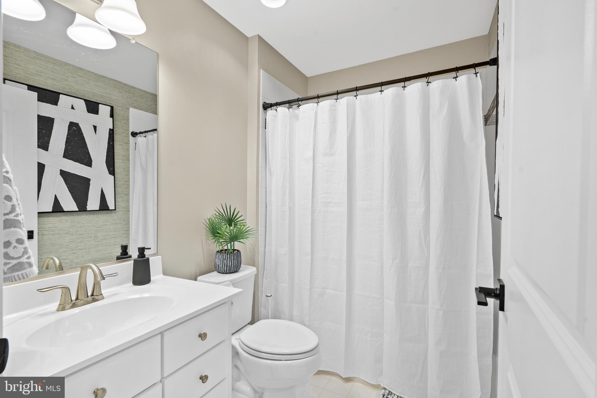3822 Jacob Stout Road Doylestown, PA 18902 - Photo 7 of 39 a bathroom with a sink a toilet and shower curtain