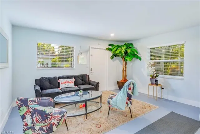 a living room with furniture and a potted plant