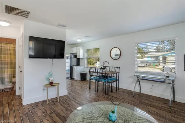 a living room with furniture a rug and a flat screen tv